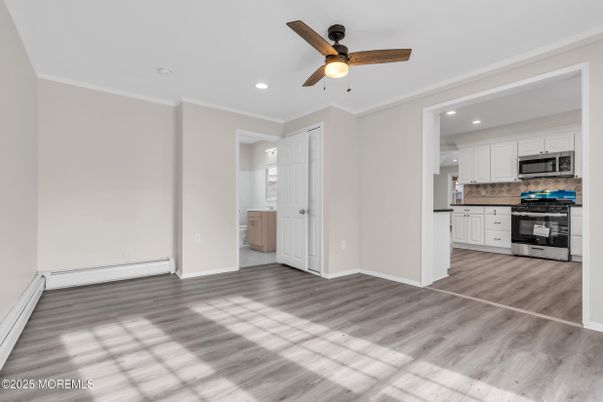 Empty room, Interior, Kitchen, Recessed Lighting, Stainless Steel Appliances, Wood Texture Flooring