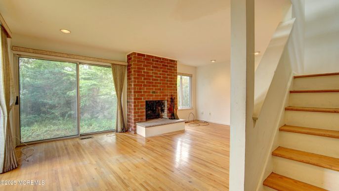 Empty room, Fireplace, Interior, Recessed Lighting, Stone Walls, Wood Texture Flooring