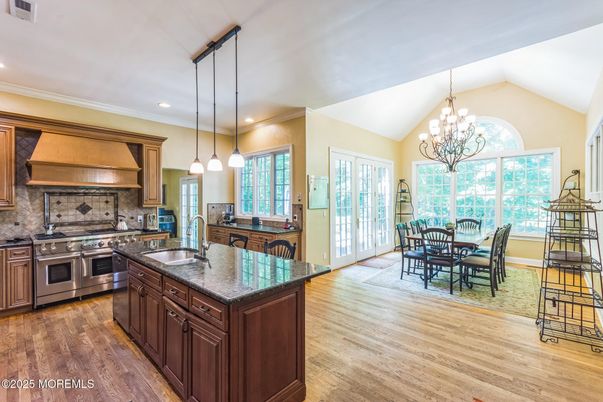 Chandelier, Dining room, Interior, Kitchen, Pendant Lights, Recessed Lighting, Stainless Steel Appliances, Wood Texture Flooring