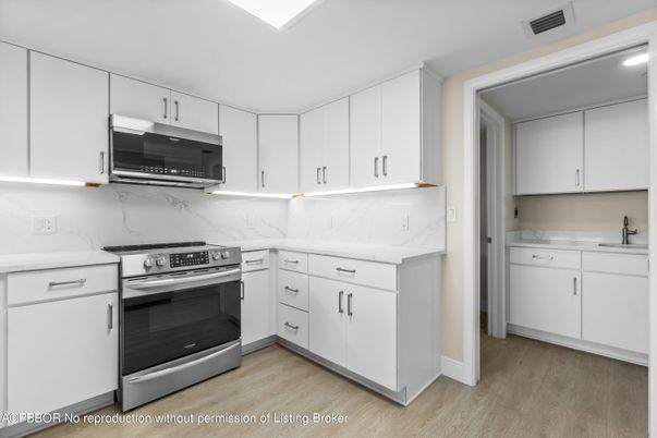 Interior, Kitchen, Marble Walls, Recessed Lighting, Stainless Steel Appliances, Wood Texture Flooring