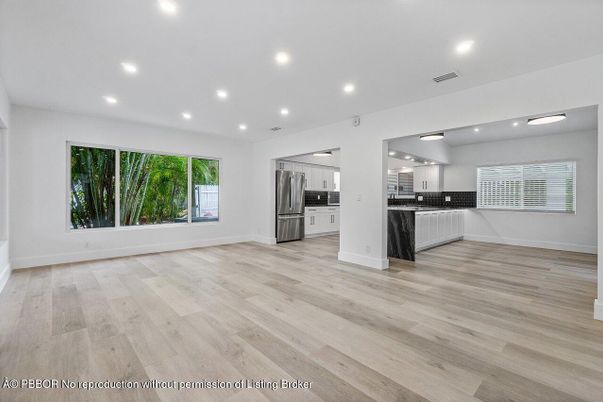 Empty room, Interior, Kitchen, Recessed Lighting, Stainless Steel Appliances, Wood Texture Flooring