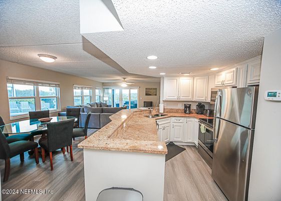 Dining room, Interior, Kitchen, Living room, Recessed Lighting, Stainless Steel Appliances, Wood Texture Flooring