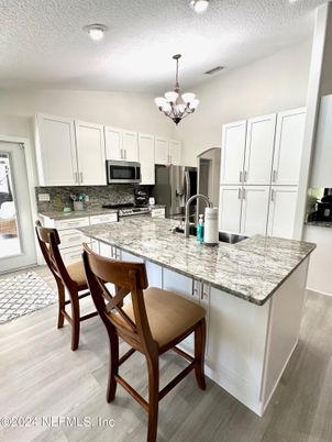Chandelier, Interior, Kitchen, Recessed Lighting, Stainless Steel Appliances, Wood Texture Flooring
