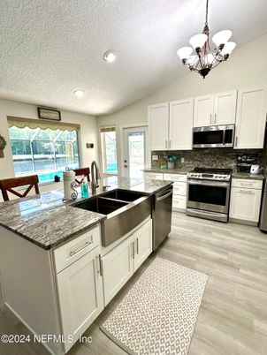 Chandelier, Interior, Kitchen, Recessed Lighting, Stainless Steel Appliances, Wood Texture Flooring