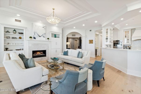 Chandelier, Fireplace, Interior, Kitchen, Living room, Pendant Lights, Recessed Lighting, Stainless Steel Appliances, Wood Texture Flooring