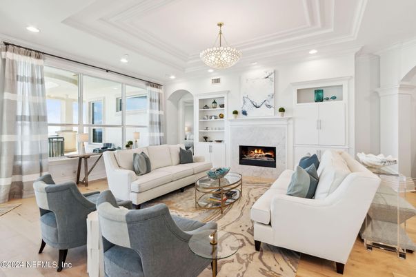 Chandelier, Fireplace, Interior, Living room, Marble Walls, Recessed Lighting, Wood Texture Flooring
