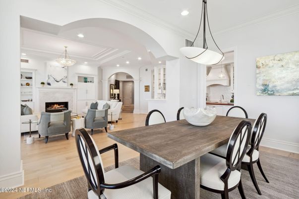 Chandelier, Dining room, Fireplace, Interior, Living room, Pendant Lights, Recessed Lighting, Wood Texture Flooring