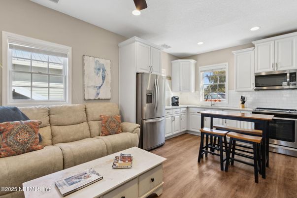 Dining room, Interior, Kitchen, Living room, Recessed Lighting, Stainless Steel Appliances, Wood Texture Flooring