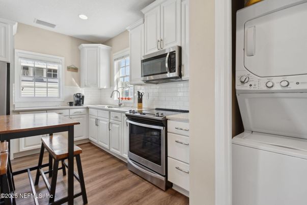 Interior, Kitchen, Recessed Lighting, Washer, Wood Texture Flooring