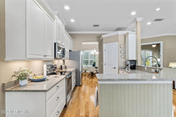 Chandelier, Dining room, Interior, Kitchen, Recessed Lighting, Stainless Steel Appliances, Wood Texture Flooring