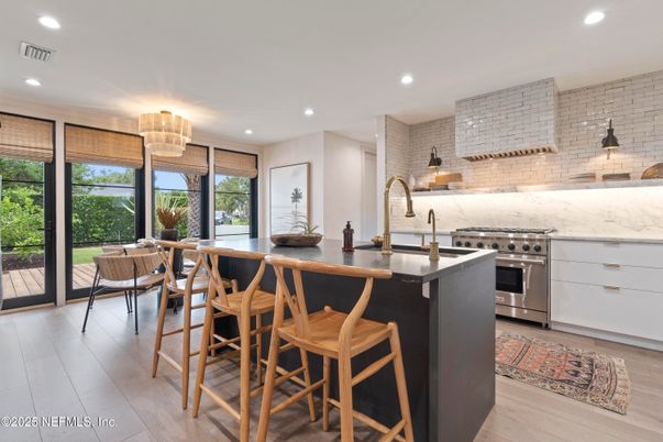 Chandelier, Dining room, Interior, Kitchen, Recessed Lighting, Stainless Steel Appliances, Stone Walls, Wood Texture Flooring