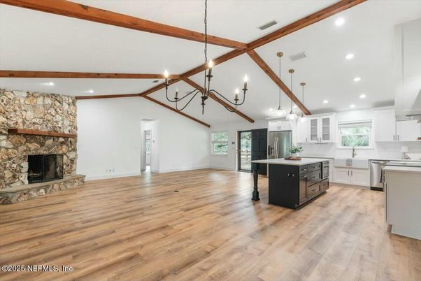 Chandelier, Fireplace, Interior, Kitchen, Pendant Lights, Recessed Lighting, Stainless Steel Appliances, Stone Walls, Wooden Beams, Wood Texture Flooring