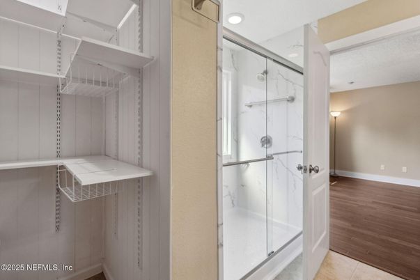 Bathroom, Glass Shower, Interior, Marble Walls, Recessed Lighting, Wood Texture Flooring