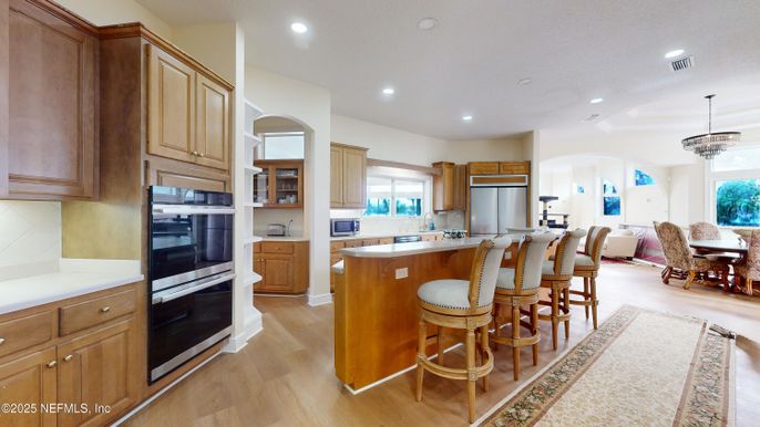 Chandelier, Dining room, Interior, Kitchen, Pendant Lights, Recessed Lighting, Stainless Steel Appliances, Wood Texture Flooring