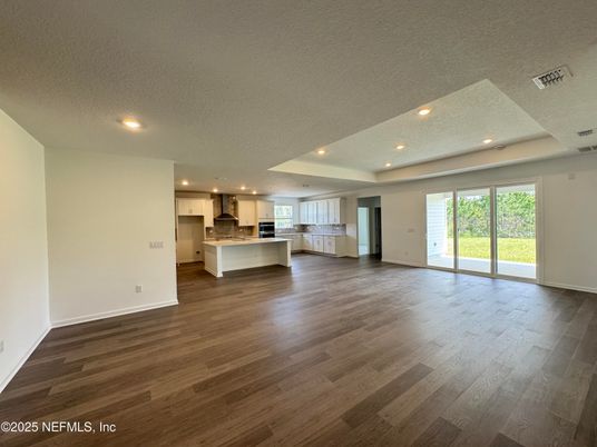 Empty room, Interior, Kitchen, Recessed Lighting, Stainless Steel Appliances, Wood Texture Flooring