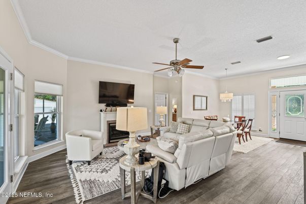 Chandelier, Dining room, Fireplace, Interior, Living room, Pendant Lights, Recessed Lighting, Wood Texture Flooring