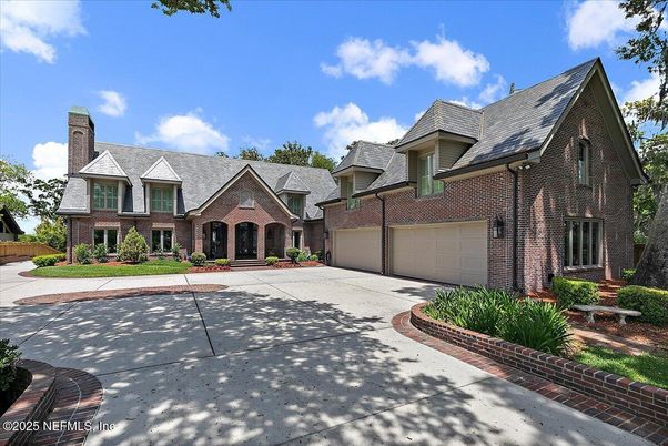 Attached, Exterior, Facade, Brick Facade, Solar Panels, Tudor Revival