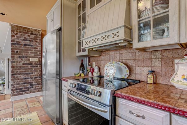 Interior, Kitchen, Stainless Steel Appliances, Stone Walls, Tile Countertops