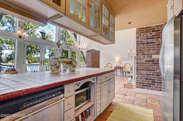Interior, Kitchen, Recessed Lighting, Stainless Steel Appliances, Stone Walls, Tile Countertops