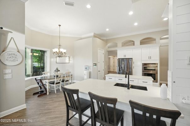 Chandelier, Dining room, Interior, Kitchen, Pendant Lights, Recessed Lighting, Stainless Steel Appliances, Wood Texture Flooring