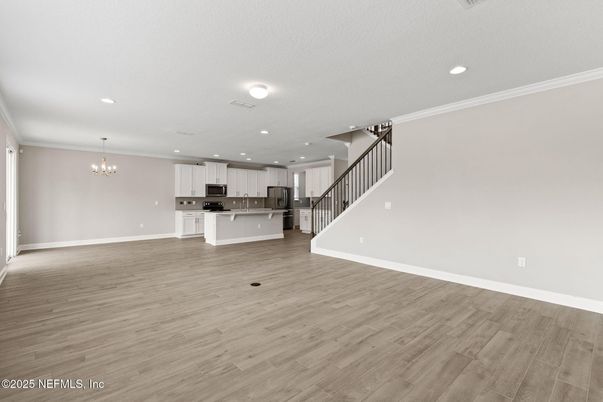 Chandelier, Empty room, Interior, Kitchen, Recessed Lighting, Stainless Steel Appliances, Wood Texture Flooring