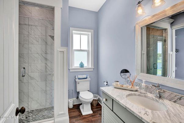 Bathroom, Dual Sink Vanities, Glass Shower, Interior, Marble Walls, Wood Texture Flooring