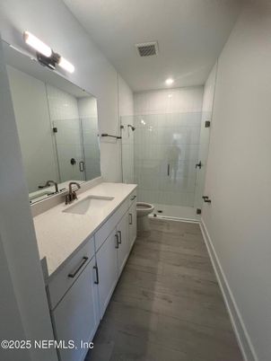 Bathroom, Dual Sink Vanities, Glass Shower, Interior, Recessed Lighting, Wood Texture Flooring