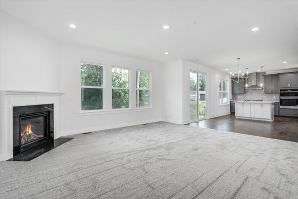 Empty room, Fireplace, Interior, Kitchen, Pendant Lights, Recessed Lighting, Stainless Steel Appliances, Wood Texture Flooring