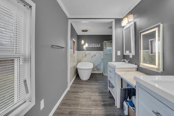 Bathroom, Dual Sink Vanities, Free Standing Baths, Interior, Marble Walls, Pendant Lights, Wood Texture Flooring