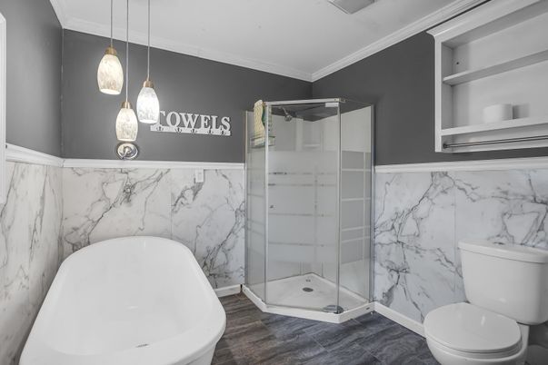 Bathroom, Free Standing Baths, Glass Shower, Interior, Marble Walls, Pendant Lights, Wood Texture Flooring