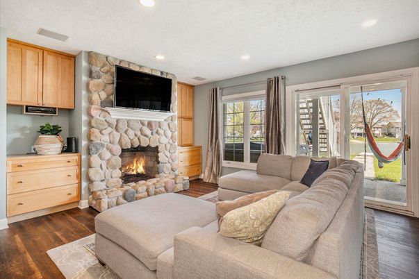 Fireplace, Interior, Living room, Recessed Lighting, Stone Walls, Wood Texture Flooring