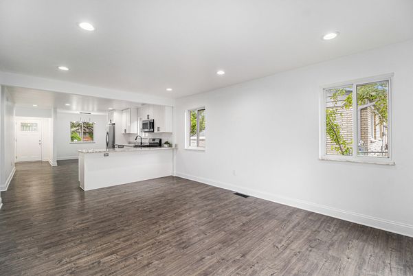 Empty room, Interior, Kitchen, Recessed Lighting, Stainless Steel Appliances, Wood Texture Flooring