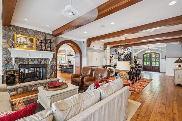 Chandelier, Dining room, Fireplace, Interior, Living room, Pendant Lights, Recessed Lighting, Stone Walls, Wooden Beams, Wood Texture Flooring