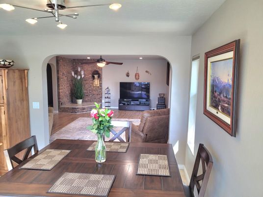Dining room, Fireplace, Interior, Living room, Recessed Lighting, Stone Walls, Wood Texture Flooring