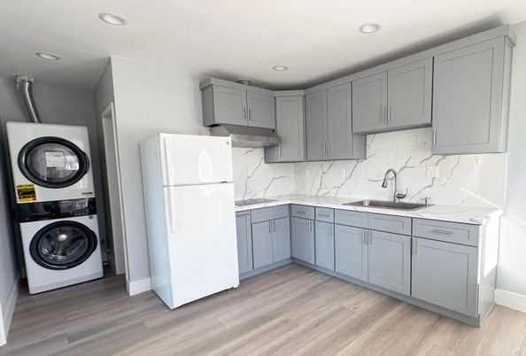 Interior, Kitchen, Marble Walls, Recessed Lighting, Washer, Wood Texture Flooring