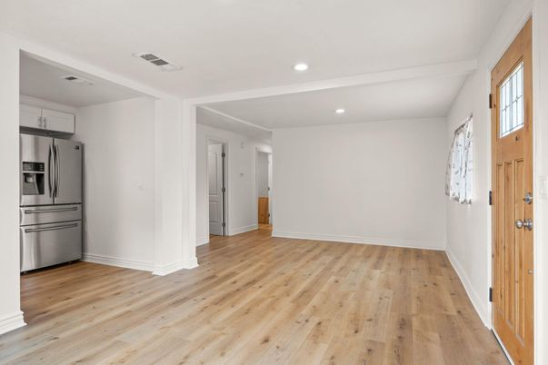 Empty room, Interior, Kitchen, Recessed Lighting, Stainless Steel Appliances, Wood Texture Flooring