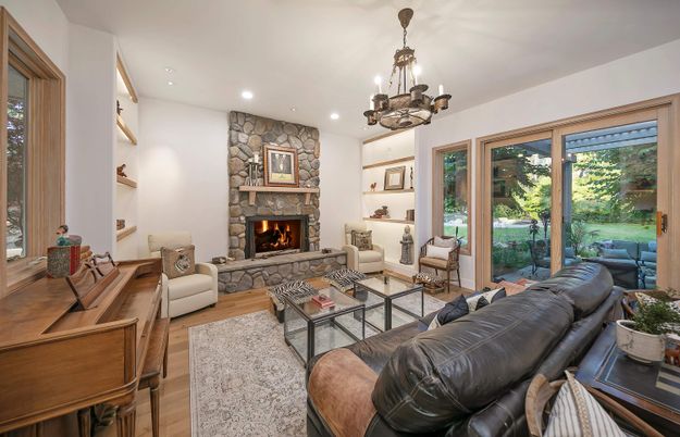 Chandelier, Fireplace, Interior, Living room, Recessed Lighting, Stone Walls, Wood Texture Flooring