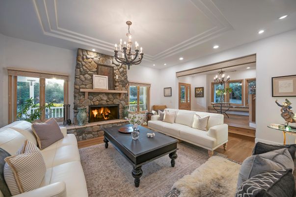 Chandelier, Fireplace, Interior, Living room, Recessed Lighting, Stone Walls, Wood Texture Flooring