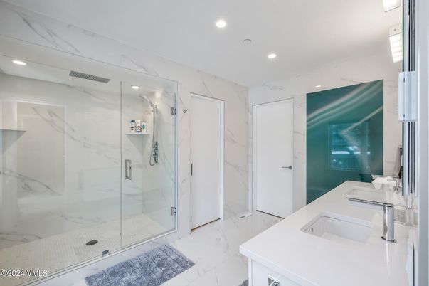 Bathroom, Dual Sink Vanities, Glass Shower, Interior, Marble, Marble Walls, Recessed Lighting