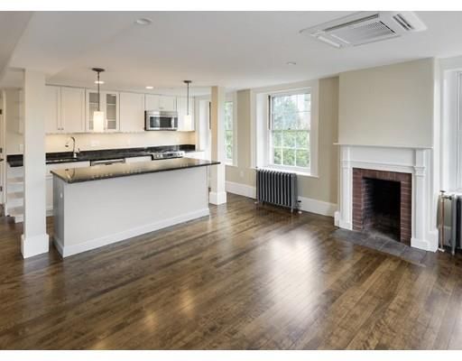 Empty room, Fireplace, Interior, Kitchen, Pendant Lights, Recessed Lighting, Stainless Steel Appliances, Wood Texture Flooring