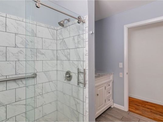 Bathroom, Glass Shower, Interior, Marble Walls, Wood Texture Flooring