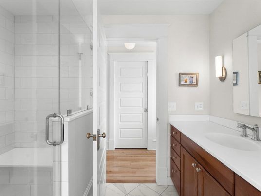 Bathroom, Dual Sink Vanities, Glass Shower, Interior, Marble, Wood Texture Flooring