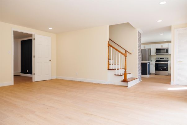 Empty room, Interior, Kitchen, Recessed Lighting, Stainless Steel Appliances, Wood Texture Flooring