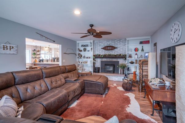 Fireplace, Interior, Living room, Recessed Lighting, Stone Walls, Wood Texture Flooring