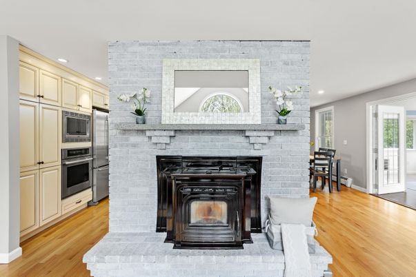 Dining room, Fireplace, Interior, Kitchen, Recessed Lighting, Stainless Steel Appliances, Stone Walls, Wood Texture Flooring