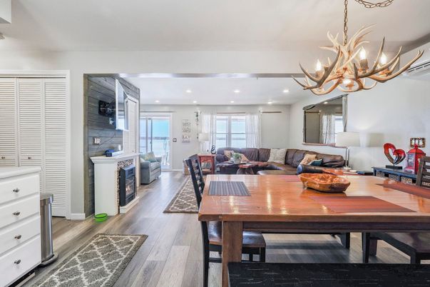 Chandelier, Dining room, Fireplace, Interior, Living room, Recessed Lighting, Stone Walls, Wood Texture Flooring