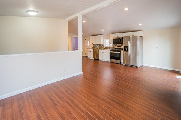 Empty room, Interior, Kitchen, Recessed Lighting, Stainless Steel Appliances, Wood Texture Flooring