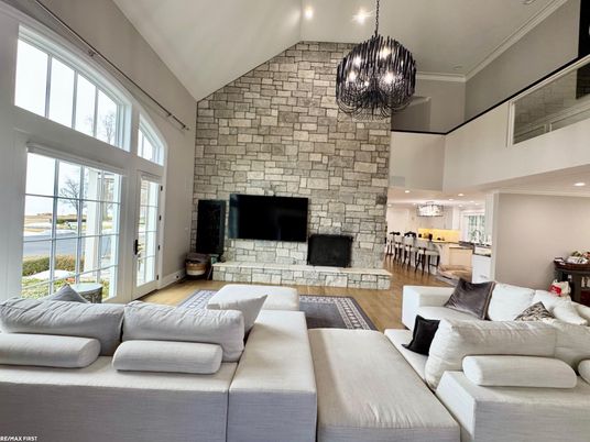 Chandelier, Fireplace, Interior, Kitchen, Living room, Pendant Lights, Recessed Lighting, Stone Walls, Wood Texture Flooring