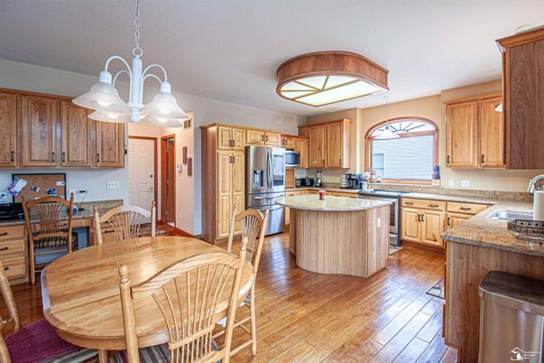 Chandelier, Dining room, Interior, Kitchen, Stainless Steel Appliances, Wood Texture Flooring