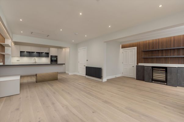 Empty room, Interior, Kitchen, Recessed Lighting, Stainless Steel Appliances, Wood Texture Flooring